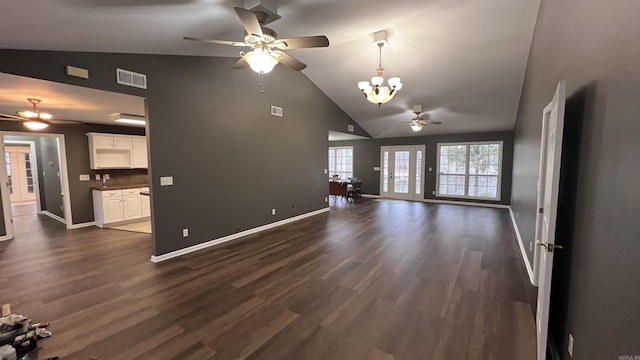 unfurnished living room featuring dark wood finished floors, visible vents, ceiling fan with notable chandelier, and baseboards