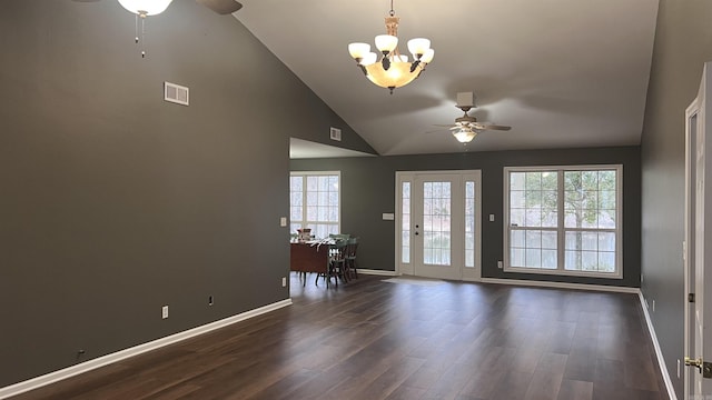 unfurnished living room featuring dark wood finished floors, ceiling fan with notable chandelier, visible vents, and baseboards