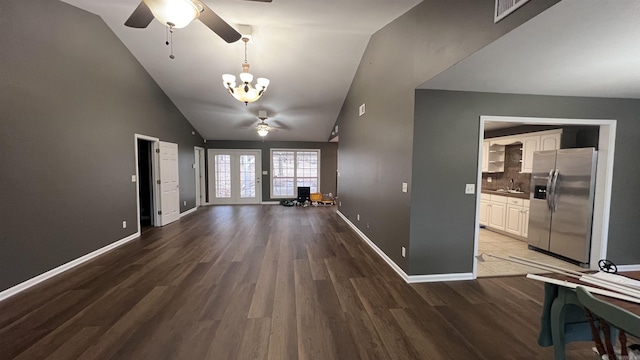 unfurnished living room featuring visible vents, baseboards, ceiling fan with notable chandelier, wood finished floors, and a sink
