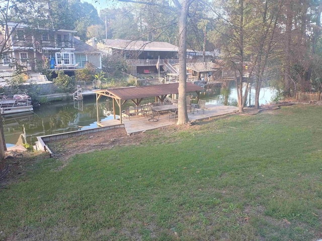 dock area featuring a water view and a yard