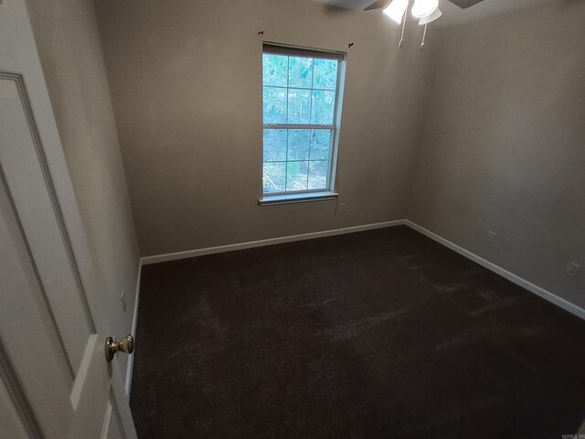 carpeted empty room featuring ceiling fan