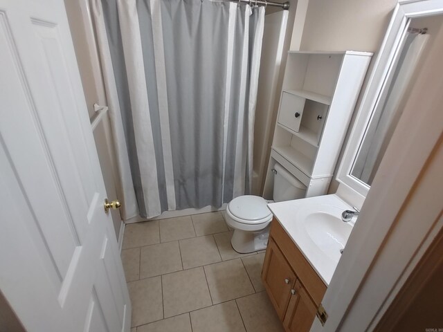 full bathroom featuring vanity, shower / bath combo, tile patterned floors, and toilet