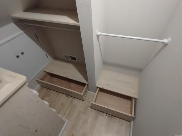 bathroom with hardwood / wood-style floors