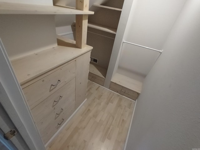 spacious closet featuring light hardwood / wood-style flooring