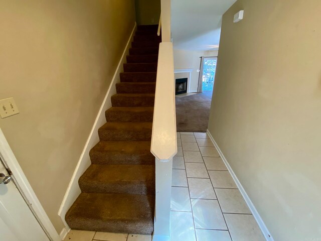 stairway with tile patterned floors