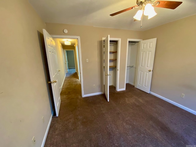 unfurnished bedroom with dark colored carpet and ceiling fan