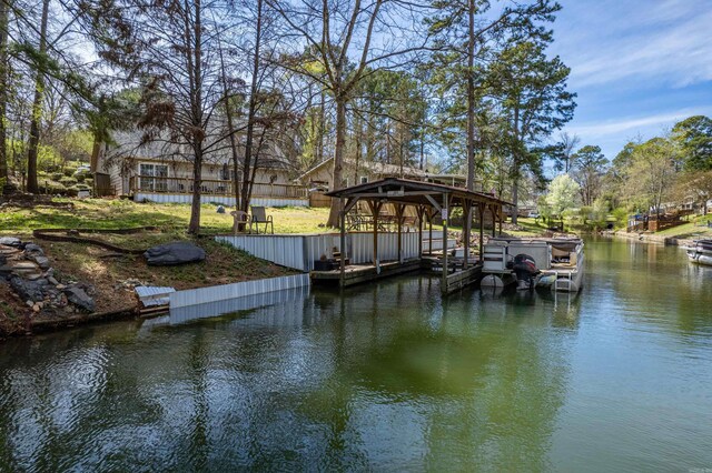 view of yard with a water view, a dock, and a patio area