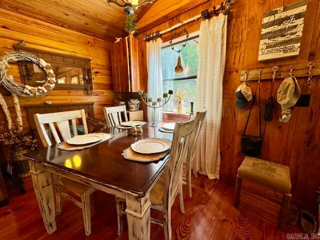 dining area with wood-type flooring and wood walls