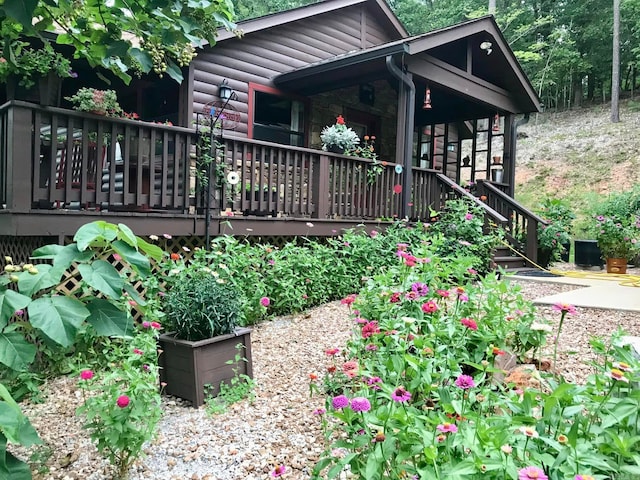 rear view of house with a wooden deck