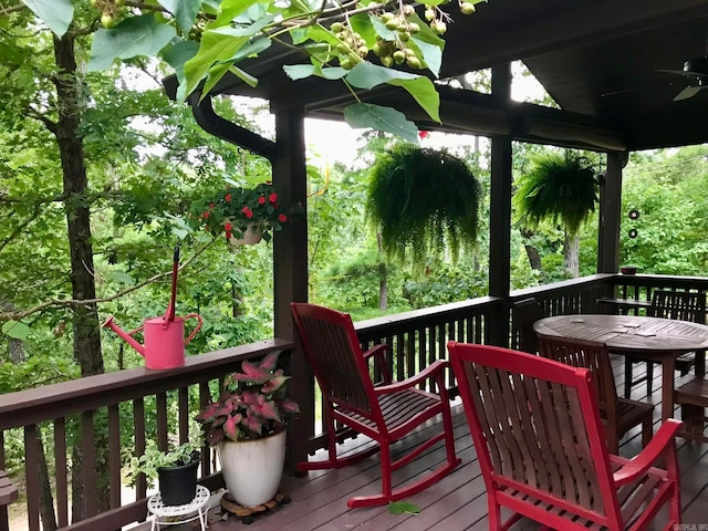 wooden deck featuring ceiling fan