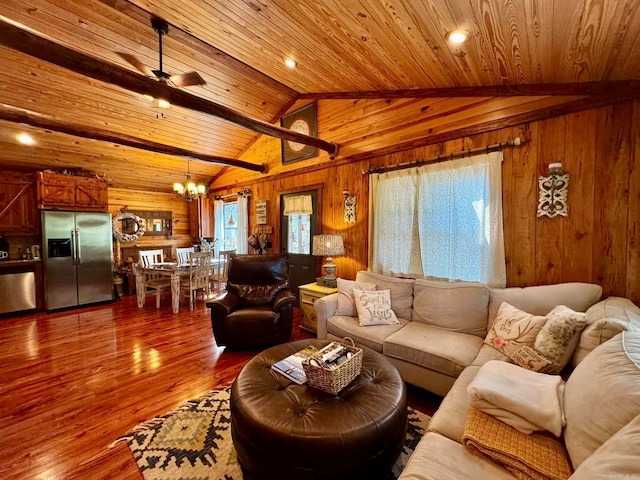 living room featuring lofted ceiling, wooden walls, hardwood / wood-style flooring, wooden ceiling, and ceiling fan with notable chandelier