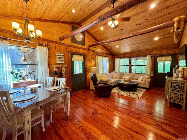 living room with ceiling fan with notable chandelier, wooden ceiling, vaulted ceiling with beams, and hardwood / wood-style flooring