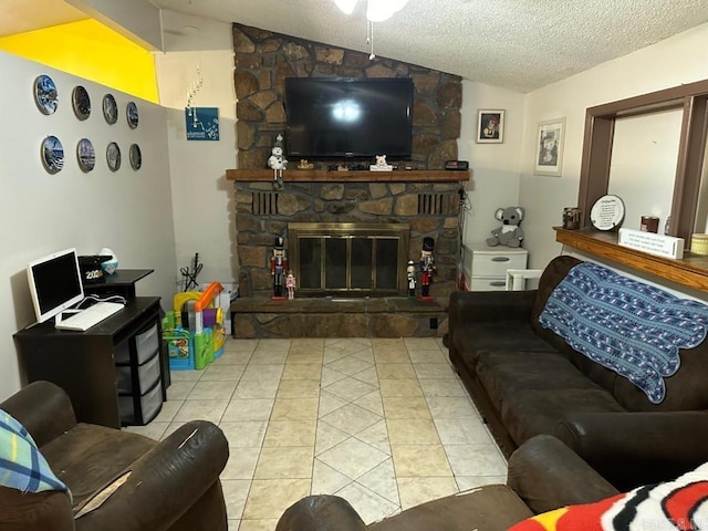 living room with a textured ceiling, lofted ceiling, light tile patterned floors, and a stone fireplace