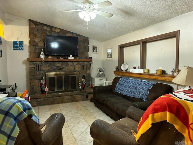 tiled living room with lofted ceiling, ceiling fan, a fireplace, and a textured ceiling