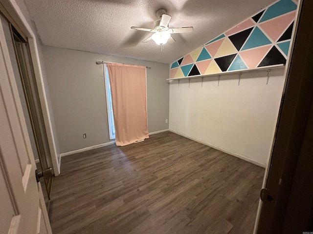 unfurnished bedroom with ceiling fan, dark hardwood / wood-style flooring, and a textured ceiling