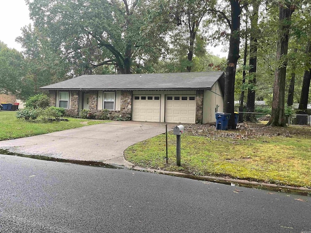 ranch-style house featuring a garage and a front lawn