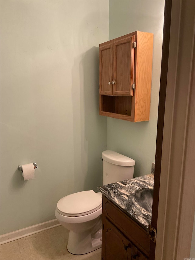 bathroom featuring tile patterned flooring, vanity, and toilet