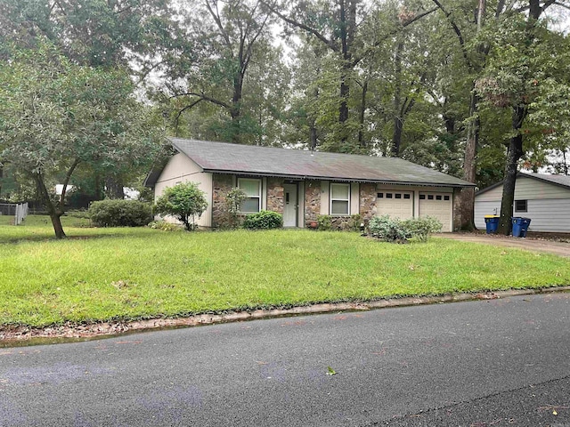 single story home with a garage and a front yard