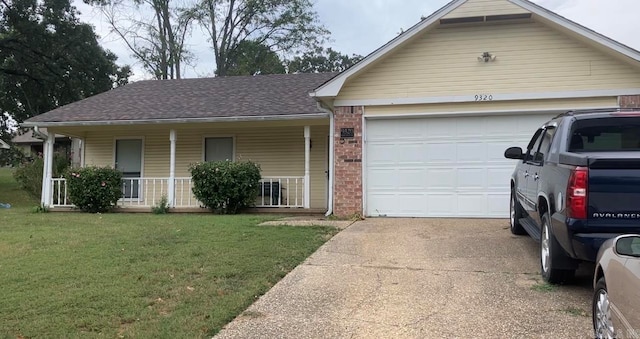 single story home with a porch, a garage, and a front yard