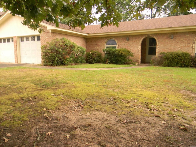 ranch-style home with a garage and a front yard