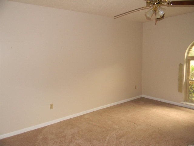 unfurnished room with ceiling fan and carpet flooring