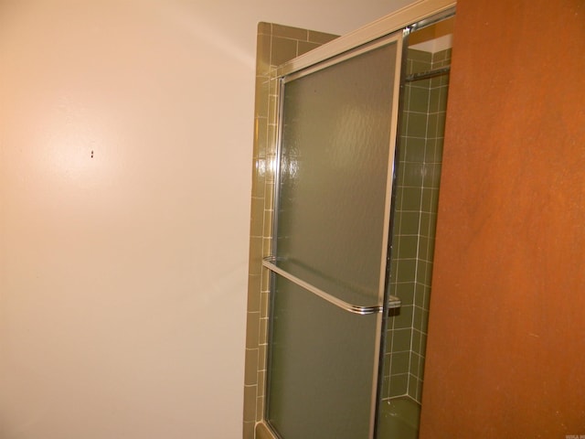 bathroom with a shower with door