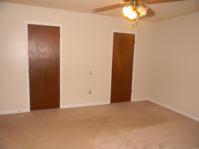 spare room with carpet and ceiling fan