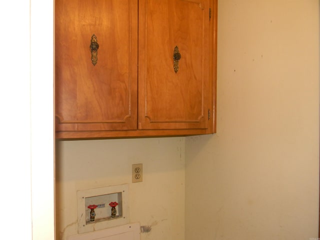 laundry room with hookup for a washing machine, cabinets, and electric dryer hookup