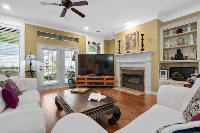 living room with dark wood-type flooring, ceiling fan, and ornamental molding