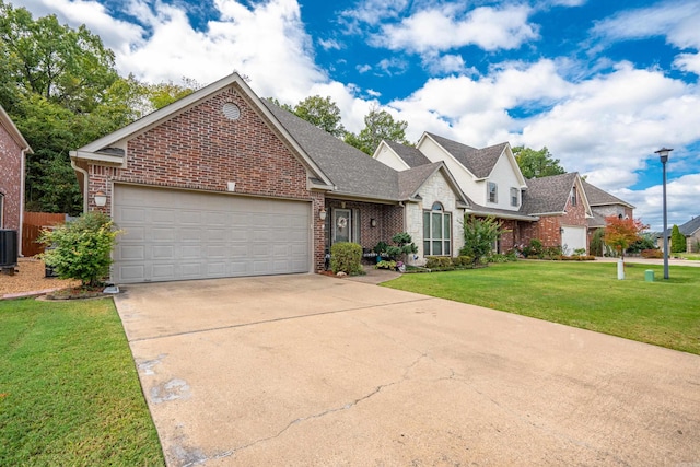 view of front of house featuring cooling unit, a front lawn, and a garage