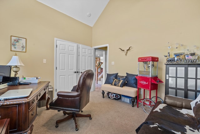 office space featuring high vaulted ceiling and light colored carpet