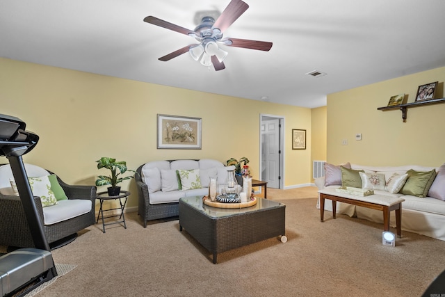 carpeted living room with ceiling fan