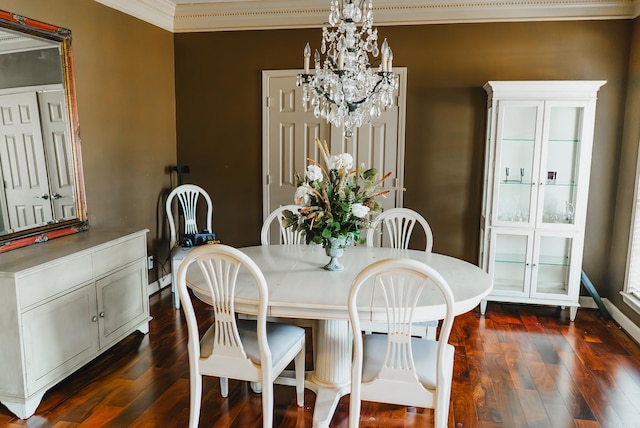 dining space featuring a chandelier, ornamental molding, and dark wood-type flooring