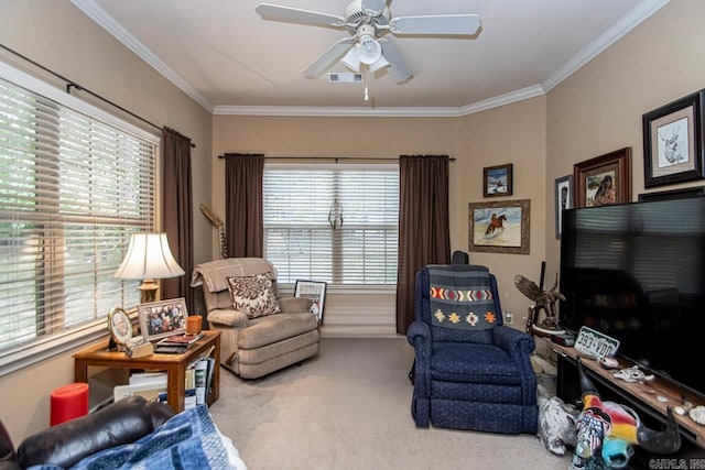 carpeted living room with crown molding and ceiling fan