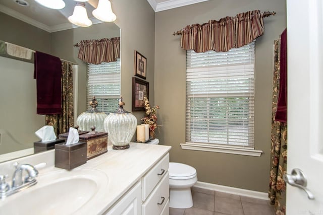 bathroom with tile patterned floors, crown molding, vanity, and toilet