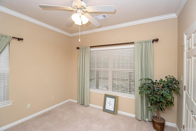 carpeted spare room featuring crown molding and ceiling fan