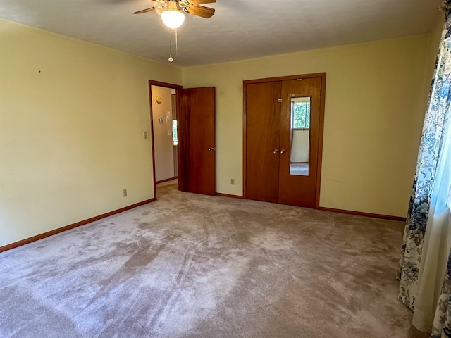 carpeted spare room with ceiling fan