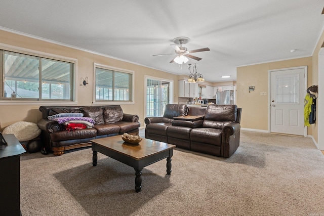 living room with light carpet, ornamental molding, ceiling fan, and a healthy amount of sunlight