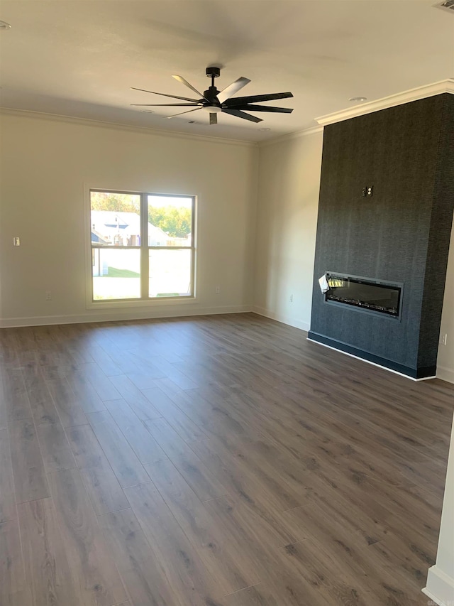 unfurnished living room with ornamental molding, ceiling fan, and dark hardwood / wood-style flooring