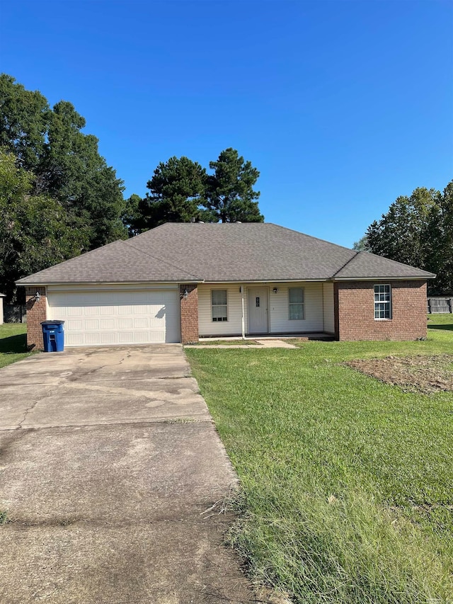 single story home featuring a front yard and a garage