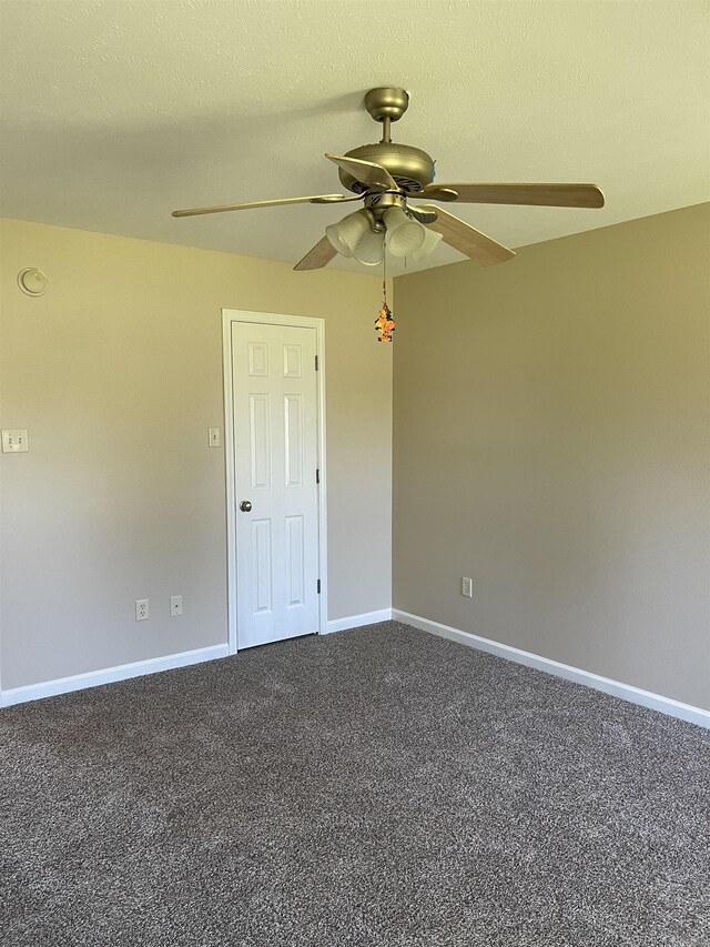 carpeted empty room featuring a textured ceiling and ceiling fan