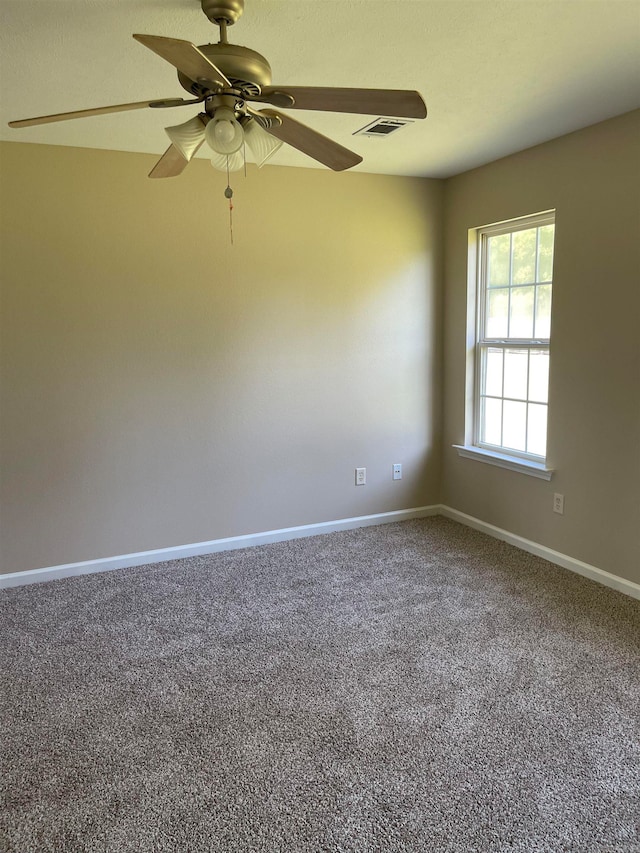 carpeted empty room featuring ceiling fan