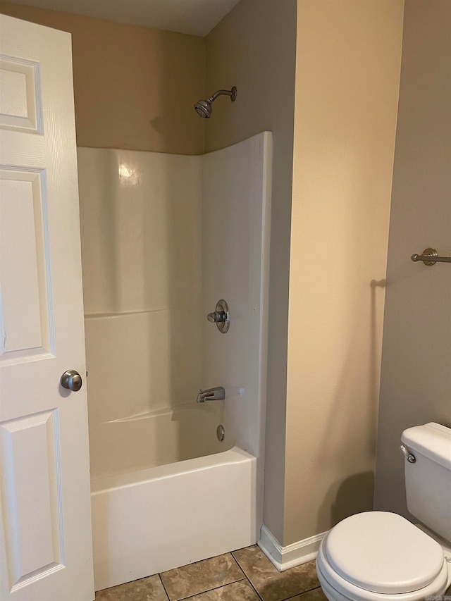 bathroom with shower / tub combination, tile patterned flooring, and toilet