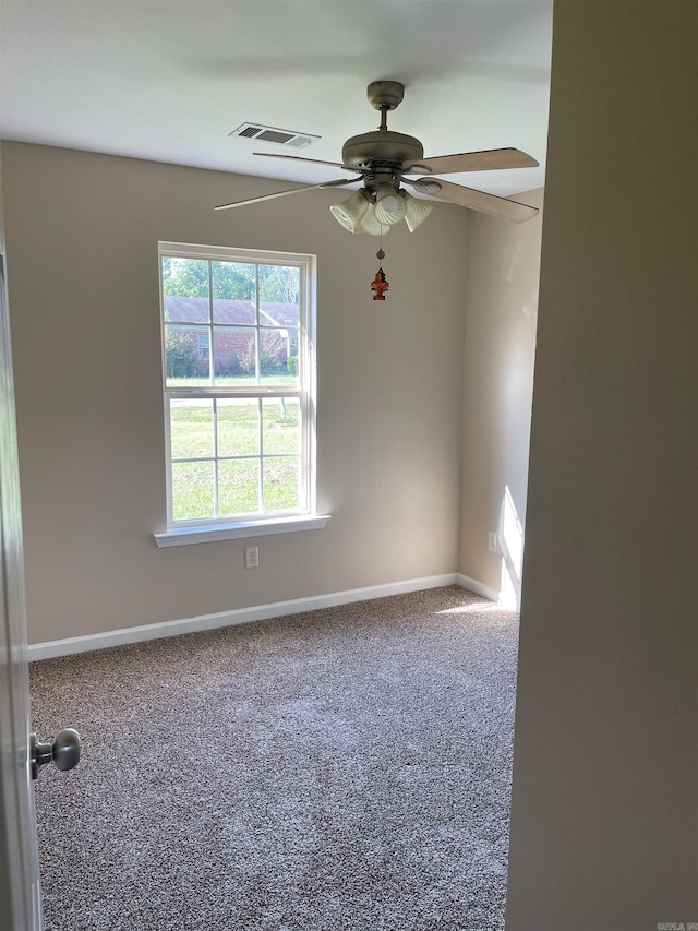 spare room featuring ceiling fan and carpet floors