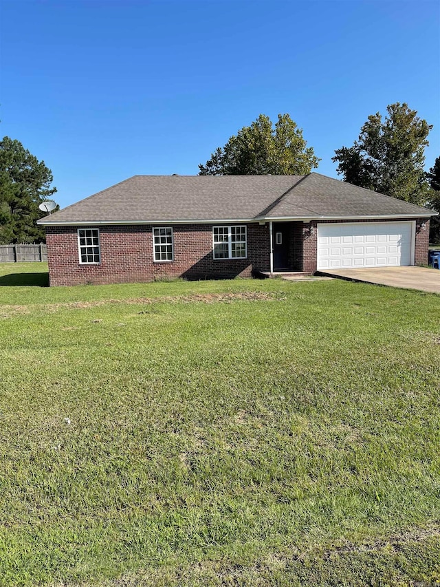 ranch-style home with a garage and a front yard