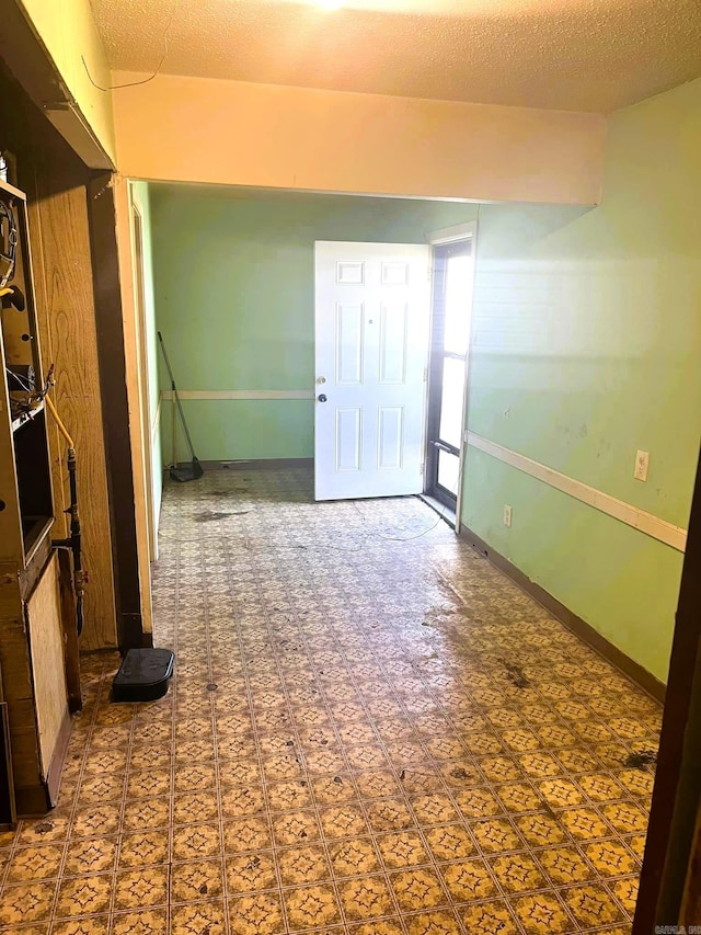 unfurnished room featuring a textured ceiling