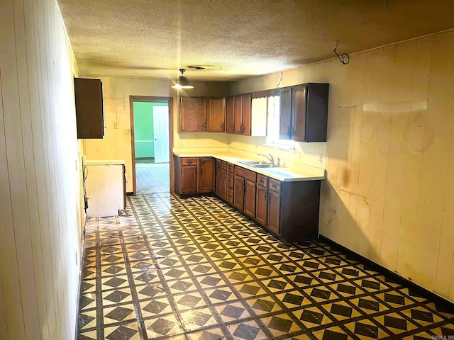 kitchen featuring a textured ceiling and sink