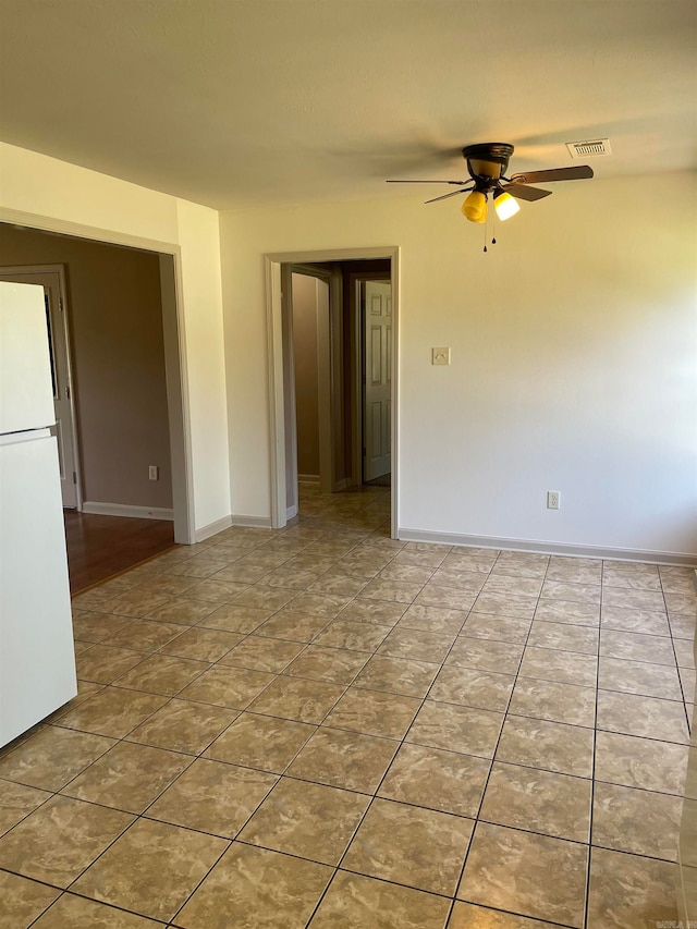 spare room with tile patterned flooring and ceiling fan