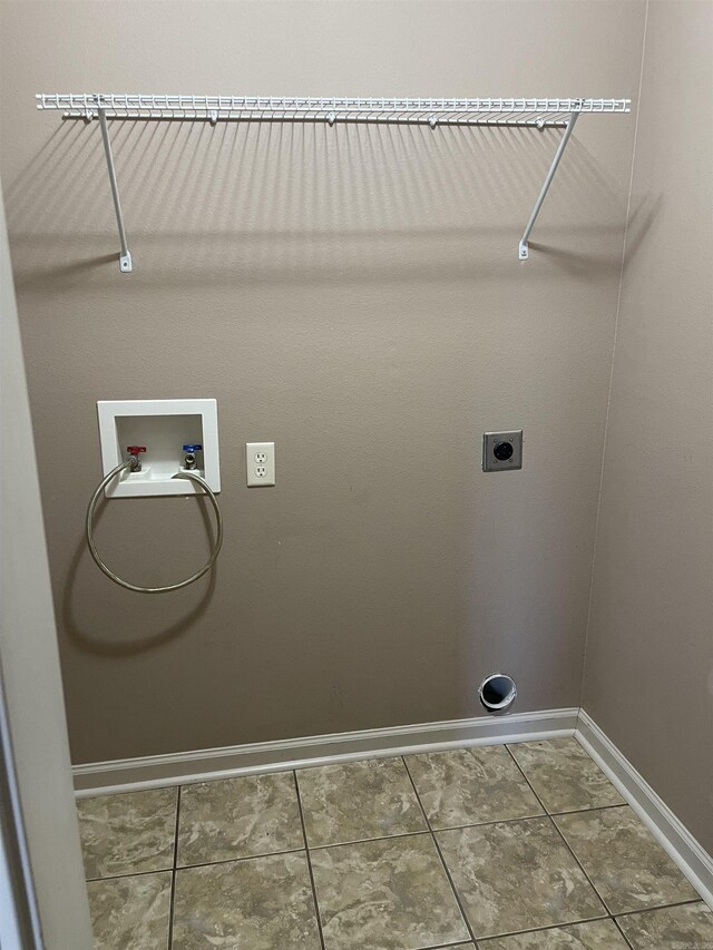 laundry room featuring hookup for an electric dryer, hookup for a washing machine, and tile patterned floors