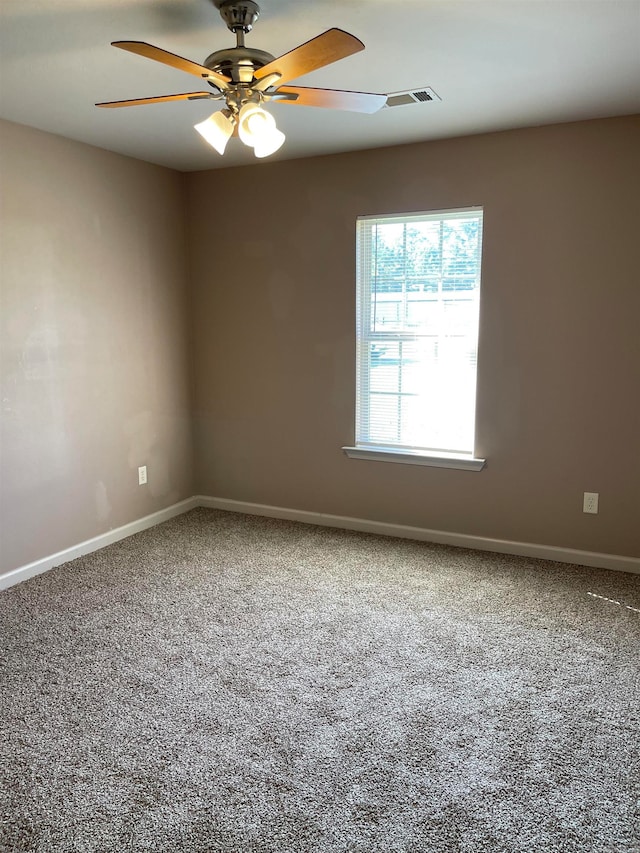 carpeted spare room featuring ceiling fan